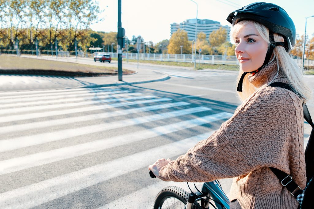 Blonde,woman,cyclist,crossing,zebra,on,the,street.,female,commuting